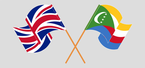 Crossed and waving flags of United Kingdom and Comoros