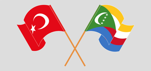 Crossed and waving flags of Turkey and Comoros