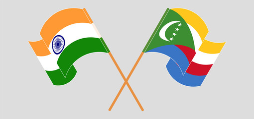 Crossed and waving flags of India and Comoros