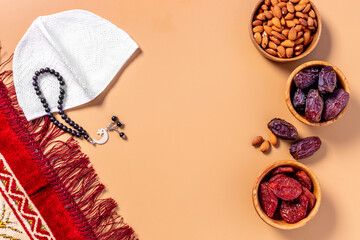 Ramadan Kareem concept. Islamic prayer carpet with rosary and dried fruits