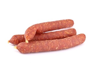 Small smoked salamis on a white background. They are traditional Austrian culinary products