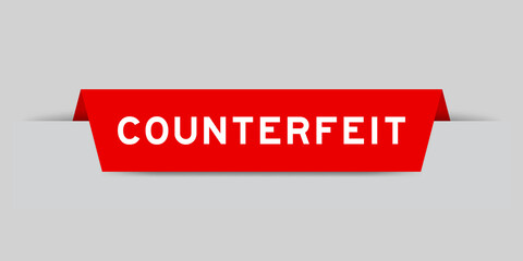 Red color inserted label with word counterfeit on gray background