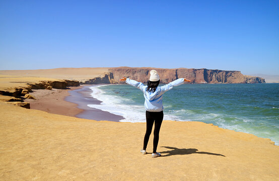 Female Visitor Being Impressed by the Red Beach or Playa Roja of Paracas National Reserve in Ica Region, Peru, South America
