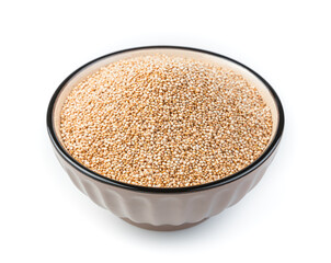 White quinoa seeds in a brown bowl are isolated on a white background in the bowl.
