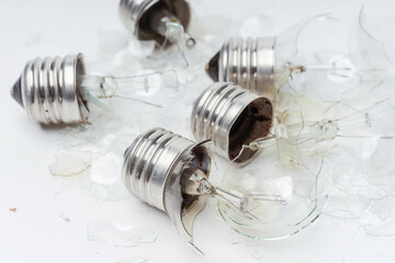 Broken light bulbs on a white background. Broken incandescent bulbs close up