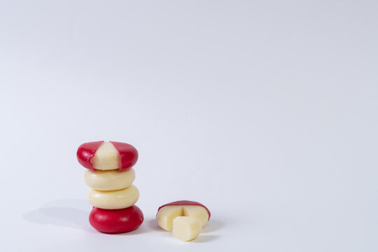 Mini Edam Ball Cheese Covered In Red Wax With White Background