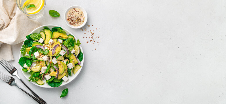 Healthy avacodo salad with feta, herbs, cucumber and nuts.