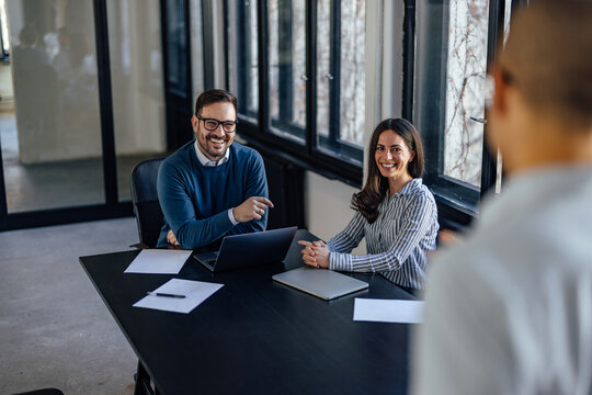 Laughing business partners, ready to interview a potential candidates for the job.