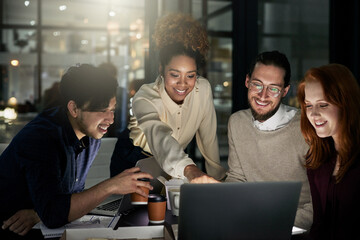 Taking their designs to the next level. Shot of a group of young designers working late in the...