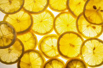 slices of fresh juicy yellow lemon on a white background. close-up. fruit background.