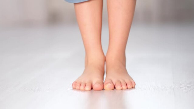 child rolls from heel to toe. Prevention of flat feet in children. Exercises for the legs. Flat feet physical therapy. close up Shot video.