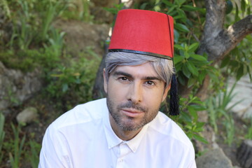 Traditional man wearing red fed hat with tassel