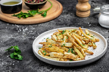 Oven roasted parsnips side dish on plate. Delicious vegetarian breakfast or snack, Clean eating, dieting, vegan food concept. top view
