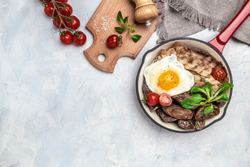 Fototapeta premium Baked sweet purple potatoes, grilled bacon and fried egg in pan and coffee on white background. Keto breakfast or lunch. Healthy fats, clean eating for weight loss, top view