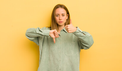 pretty caucasian woman feeling confused, clueless and unsure, weighting the good and bad in...