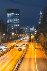 city traffic in front of skyscrapers at night in frankfurt am main, germany