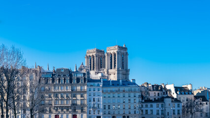 Fototapeta na wymiar Paris, Notre-Dame cathedral under construction and typical facades on the ile de la Cite 