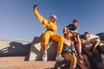 Vibrant young people taking a selfie together outdoors