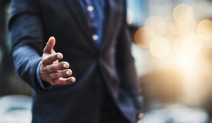 Lets make this merger happen. Closeup shot of an unrecognizable businessman extending a handshake...