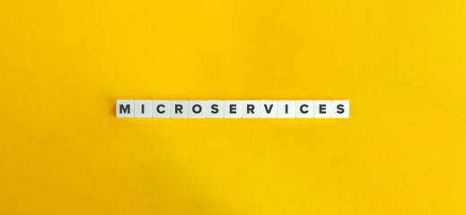 Microservices Word on Letter Tiles on Yellow Background. Minimal Aesthetics.