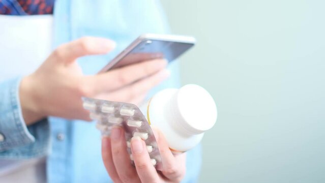 unrecognizable woman reading online medication instructions. Doctor and online consultation. Contraindications and prescription pills.