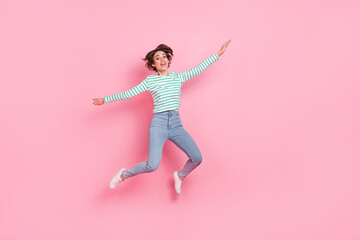 Fototapeta na wymiar Full length body size view of attractive cheerful girly funny girl jumping fooling good mood isolated over pink pastel color background