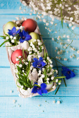 Easter. Painted eggs. Grass and flowers in a shell. Easter Still Life
