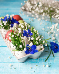 Easter. Painted eggs. Grass and flowers in a shell. Easter Still Life
