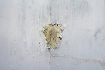 Expanding foam fills a hole in a wall - the foam has been cut ready for filling and sandpapering....