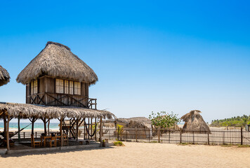 Fototapeta na wymiar The sunny day in tropical paradise, beach cabin, Caribbean Playa La Ventanilla