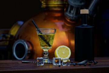 Gin cocktail with black ceramic bottle in front of distillery.