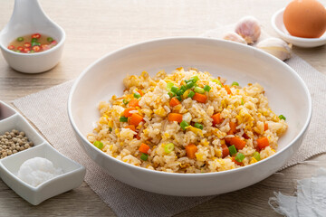 Thai Fried rice with egg and sliced carrot in white plate.Easy cooking food