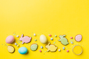 holiday preparation Multi colors Easter eggs with cookies on colored background . Pastel color Easter eggs. holiday concept with copy space