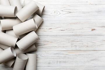 Flat lay composition with empty toilet paper rolls and space for text on color background. Recyclable paper tube with metal plug end made of kraft paper or cardboard