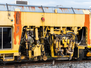 The ballast tamping machine is working to maintain the sleeper and ballast stone.