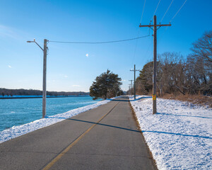 Snow on the paved footpath on the Cape Cod Canal riverbank