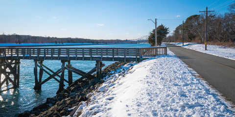 Snow on the boardwalk and riverbank along the Cape Cod Canal bikeways