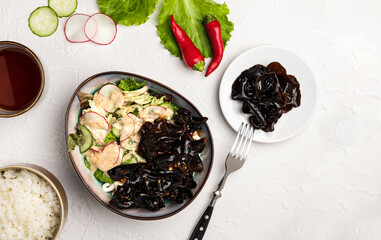 Poke of Chinese pickled wood mushroom muer in a bowl with rice, sauce, avocado, mixed salad, coconut cream. Vegetarian healthy and low-calorie dish. Horizontal orientation, top view, copy space