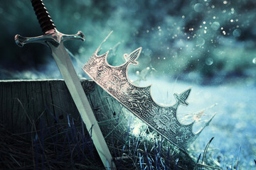 mysterious and magical photo of gold king crown and sword in the England woods. Medieval period...
