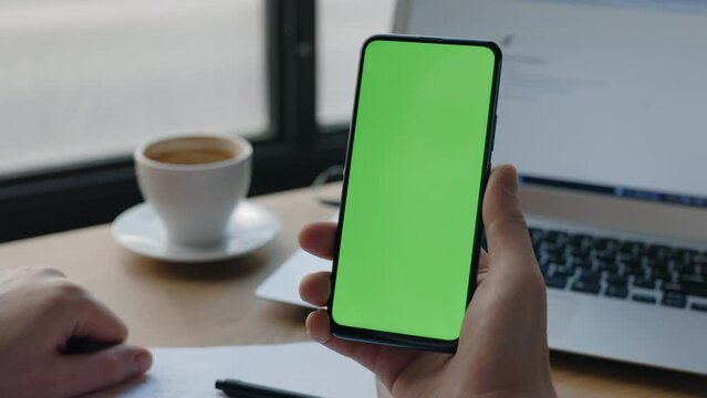 Man Typing At The Mobile Phone Vertical Green Screen. Chroma Key And Mock Up.