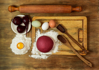 Purple dough bun for noodles with ingredients on the table.