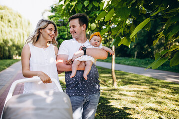 Young couple with their baby daughter in park