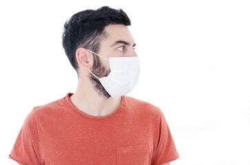 Portrait of young man with face mask looking side on copy space, isolated on white background. 2019-nCoV.
