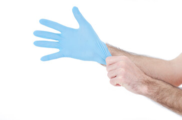 Individual protection products vinyl disposable gloves in the spread of virus and protection against infections. Men is dressing his hand in gloves. Corona virus, COVID-19.Isolated on white background