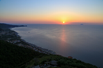 Sunset over the Mediterranean sea with clear sky. Sun over the water