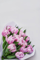 Happy Mothers Day greeting card with flowers. Bouquet of pink tulip on white background. Happy Easter template. Happy Birthday! Spring background