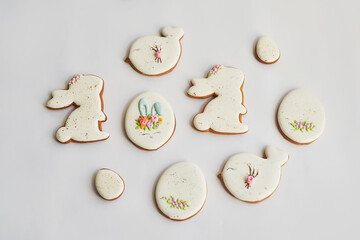 Easter greeting card with flowers, gingerbread cookies. Cookies in shape of eggs and Easter bunny....