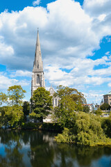 St. Alban's Church or the English Church, an Anglican church in Copenhagen, Denmark in the sunny summer day, surrounded by trees and water