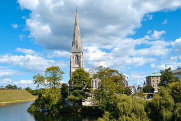 St. Alban's Church or the English Church, an Anglican church in Copenhagen, Denmark in the sunny summer day, surrounded by trees and water