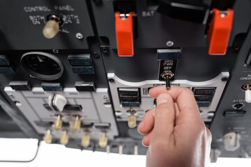 cropped view of pilot using generating off-grid power switcher in airplane simulator.